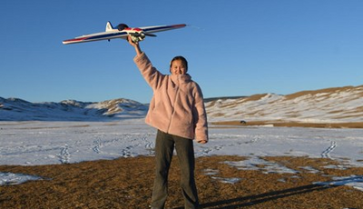 16 years old sponsored child Nomin from Mongolia holding Model Aircraft.