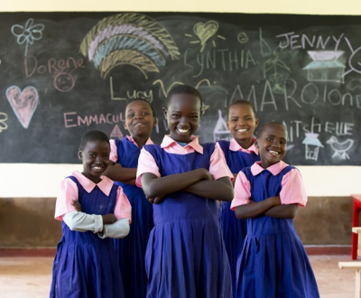 Childrens Standing in classroom infront of the blackboard 