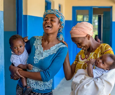 Women holding a child and laughing