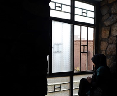 afghanistan woman sitting by the window