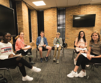 Kids in a room sitting in a chair