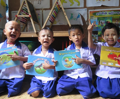 Children in school uniform reading