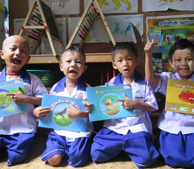 Children in school uniform reading