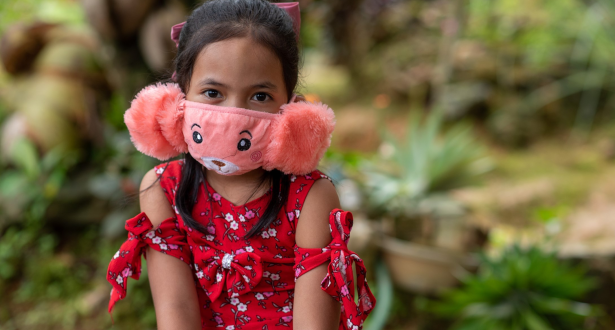 Sponsored girl from the Philippines wearing a pink facemask.