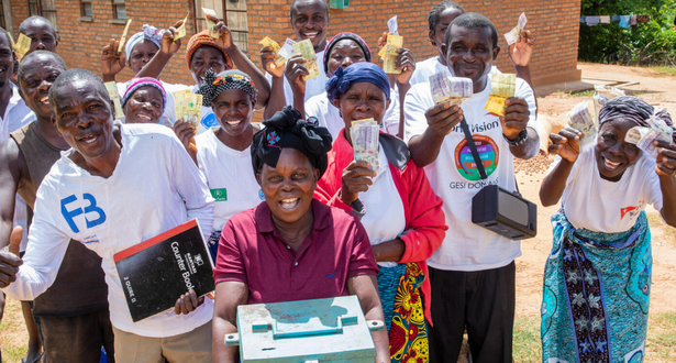 Members of the Satemwa Savings for Transformation group together with the box where they keep their savings