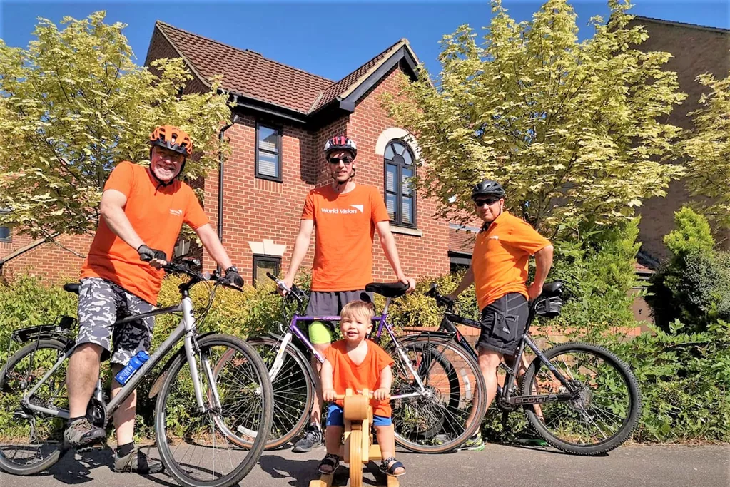 Three MEn and one kid with Cycle