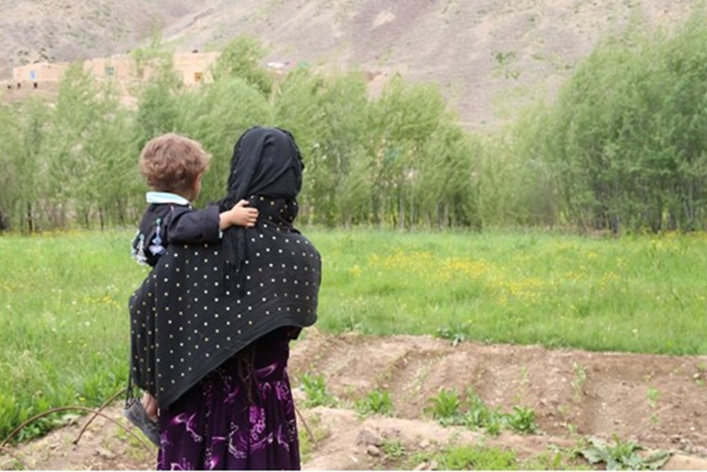 A woman carrying a child in Afghanistan