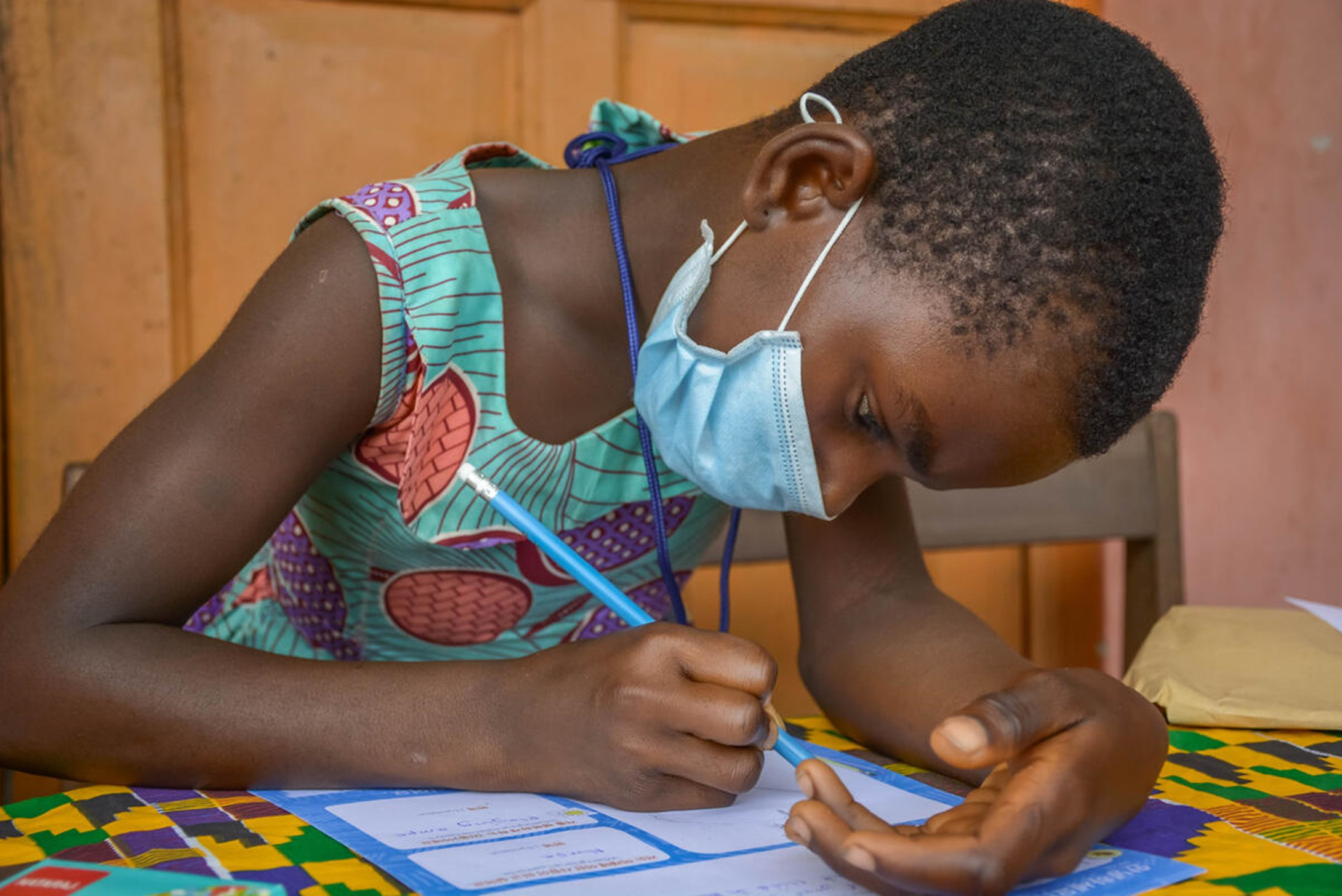 A pictures of a child in Ghana writing