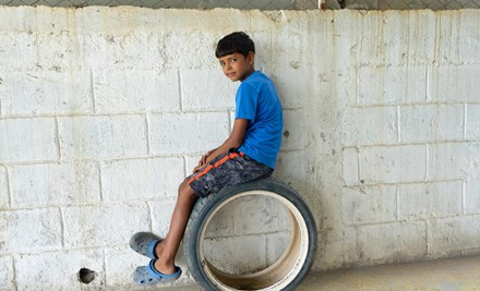 Boy sitting on a wheel