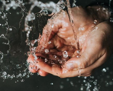 A hand holding clean water