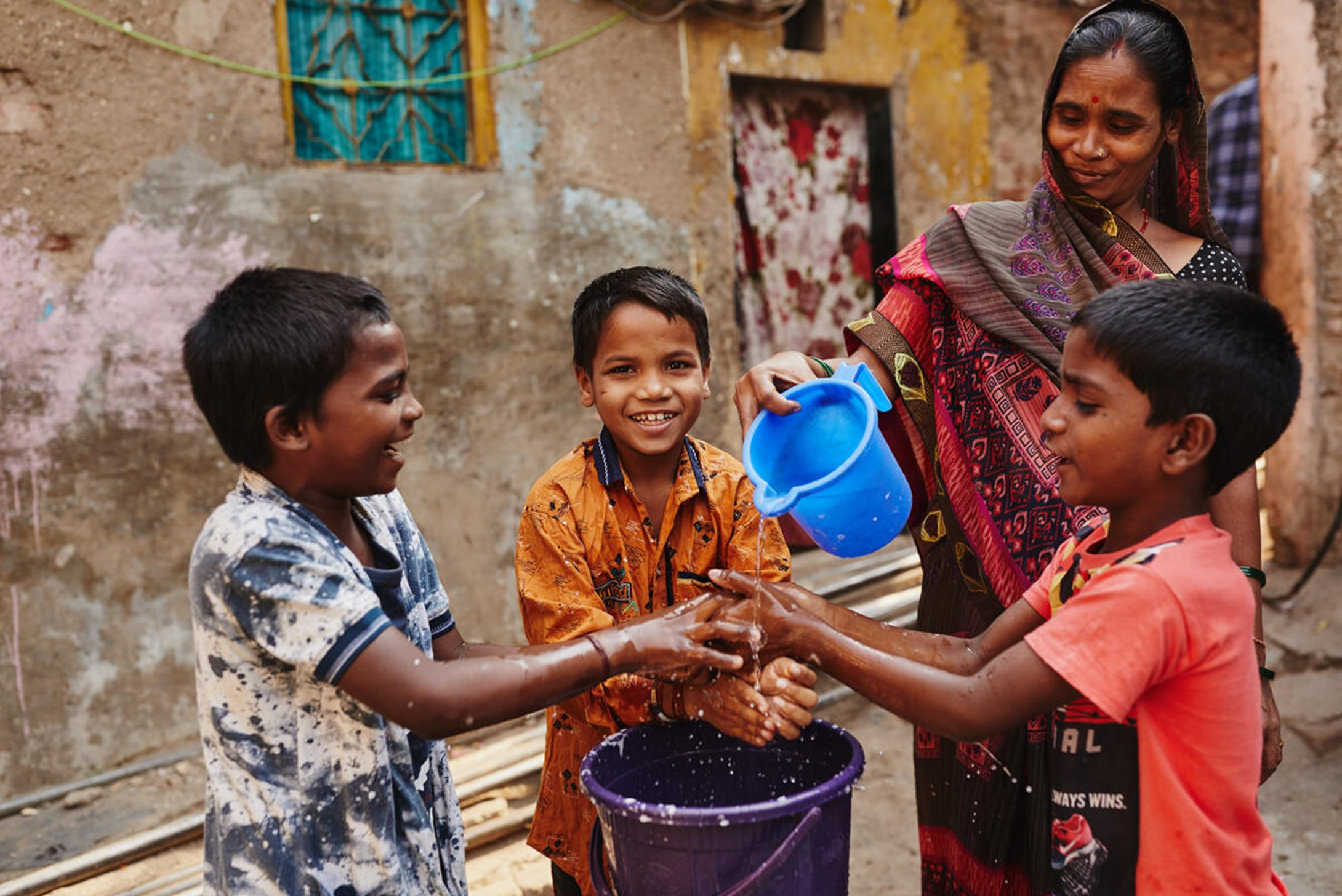 Children from India follow hygienic practices by washing their hands before and after sanitation