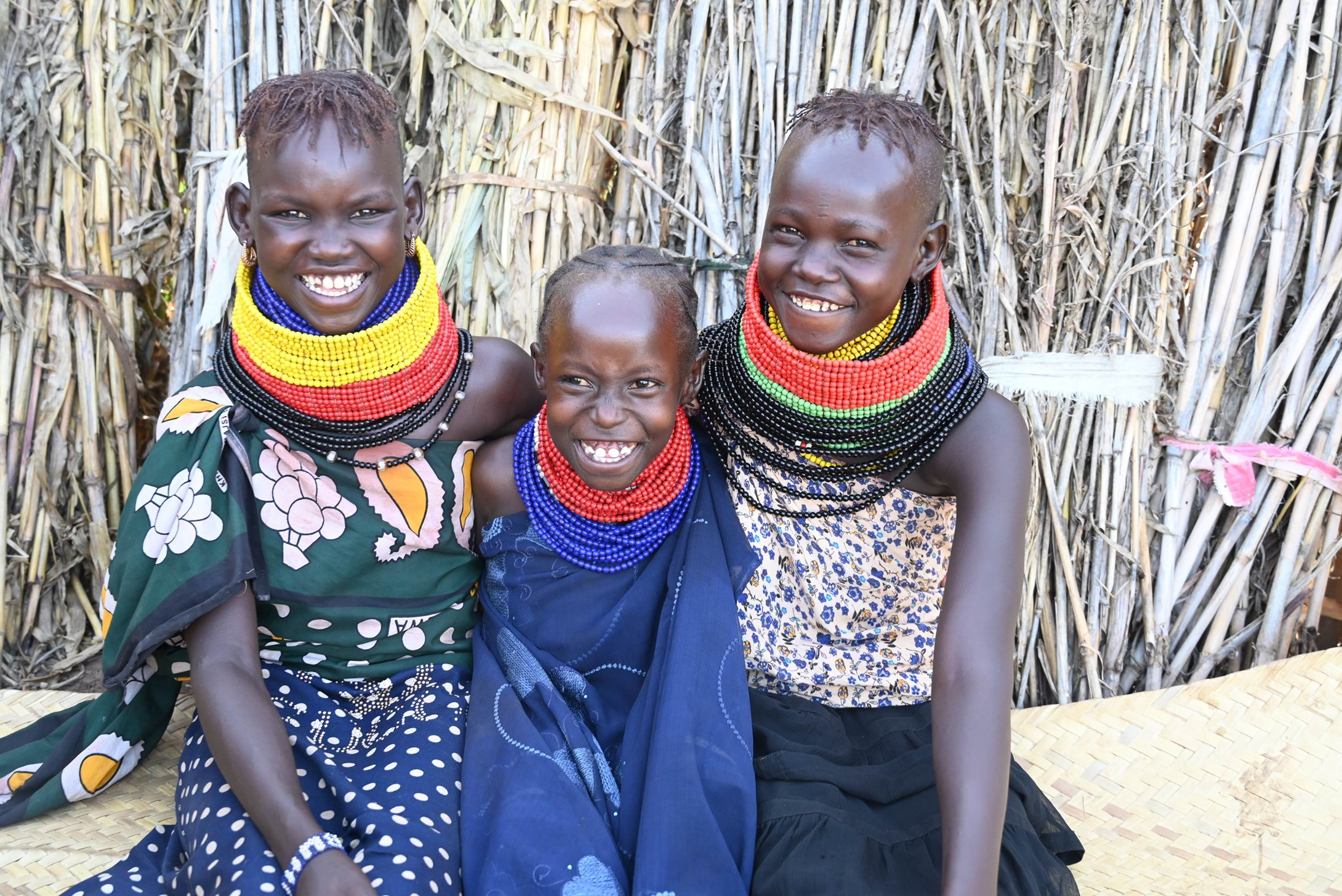 Loshru (12) with her sisters Dorcas (9) and Ajuma (11) (left to right) at their home in Turkana County, Kenya.