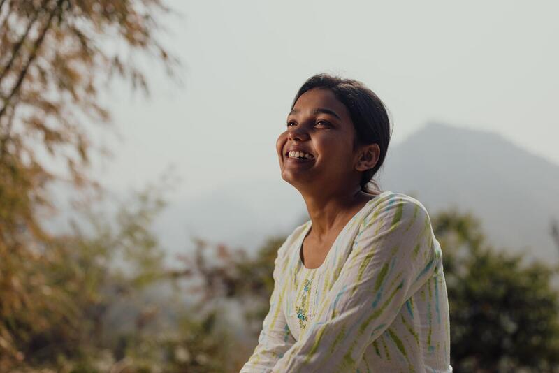 Susma looking up and smiling