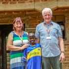 Sarah and John Osborne in Uganda with their sponsored child, Yazidi